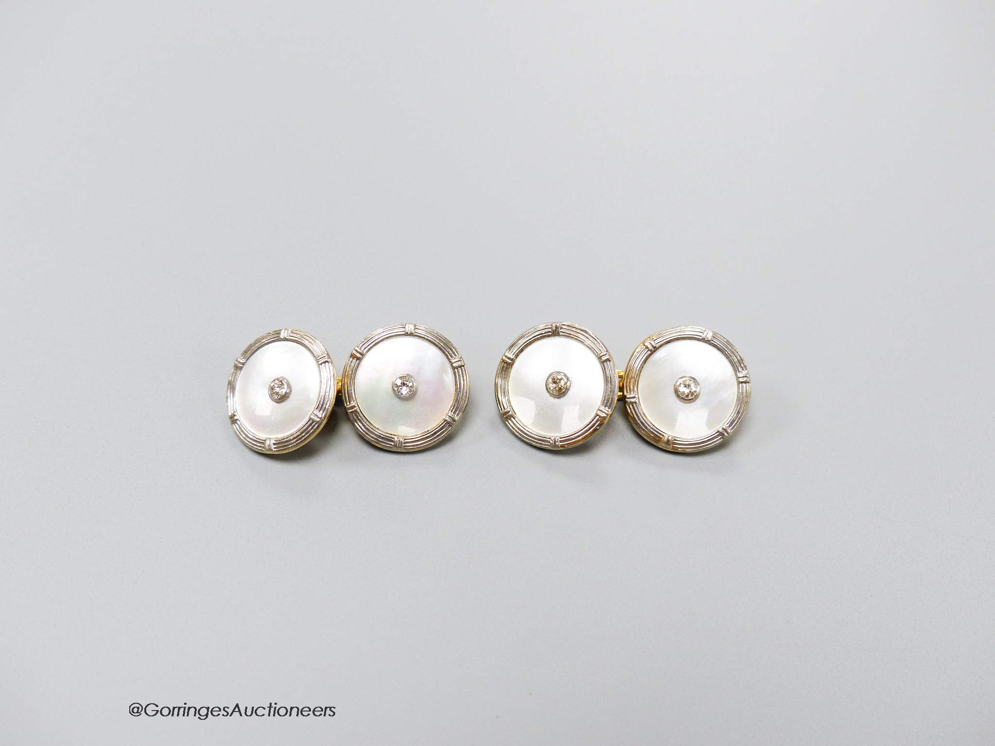 A pair of 18ct, mother of pearl and diamond set disc cufflinks